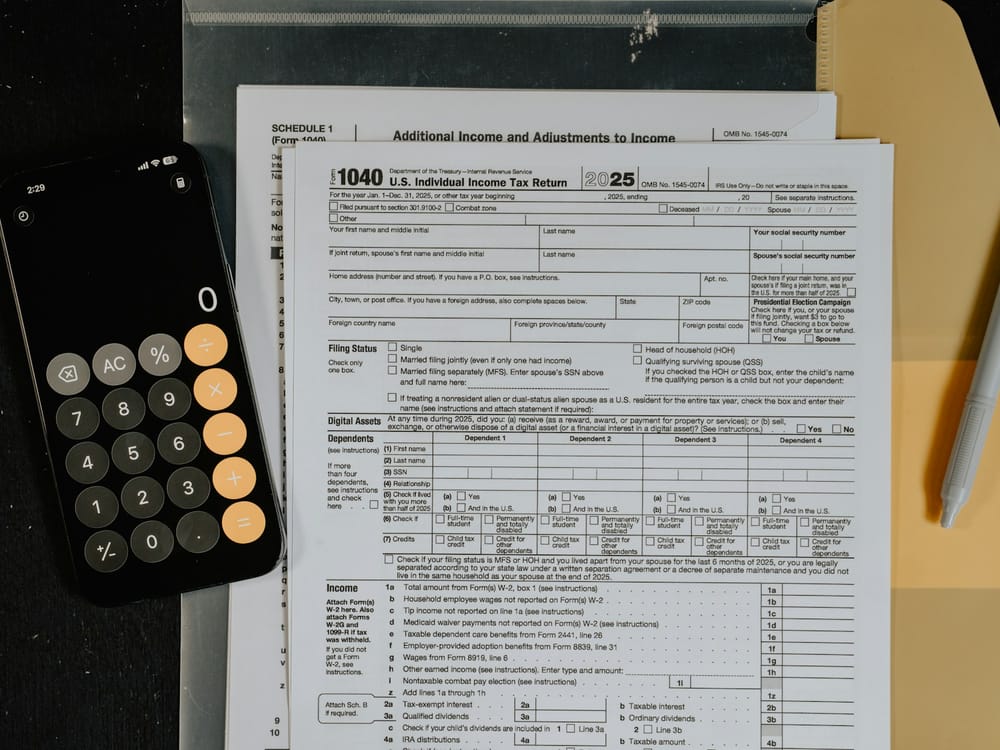 Form 1040 individual income tax return laid out with a calculator and pen
