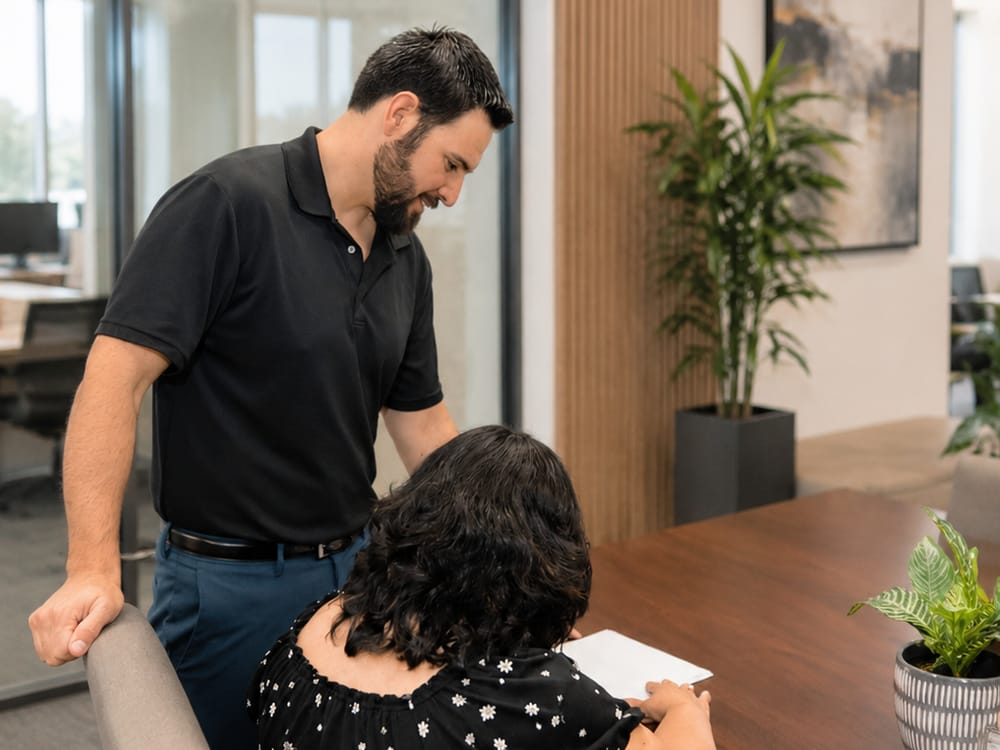 A Dunn & Ledger accountant reviewing figures with a client at the office conference table